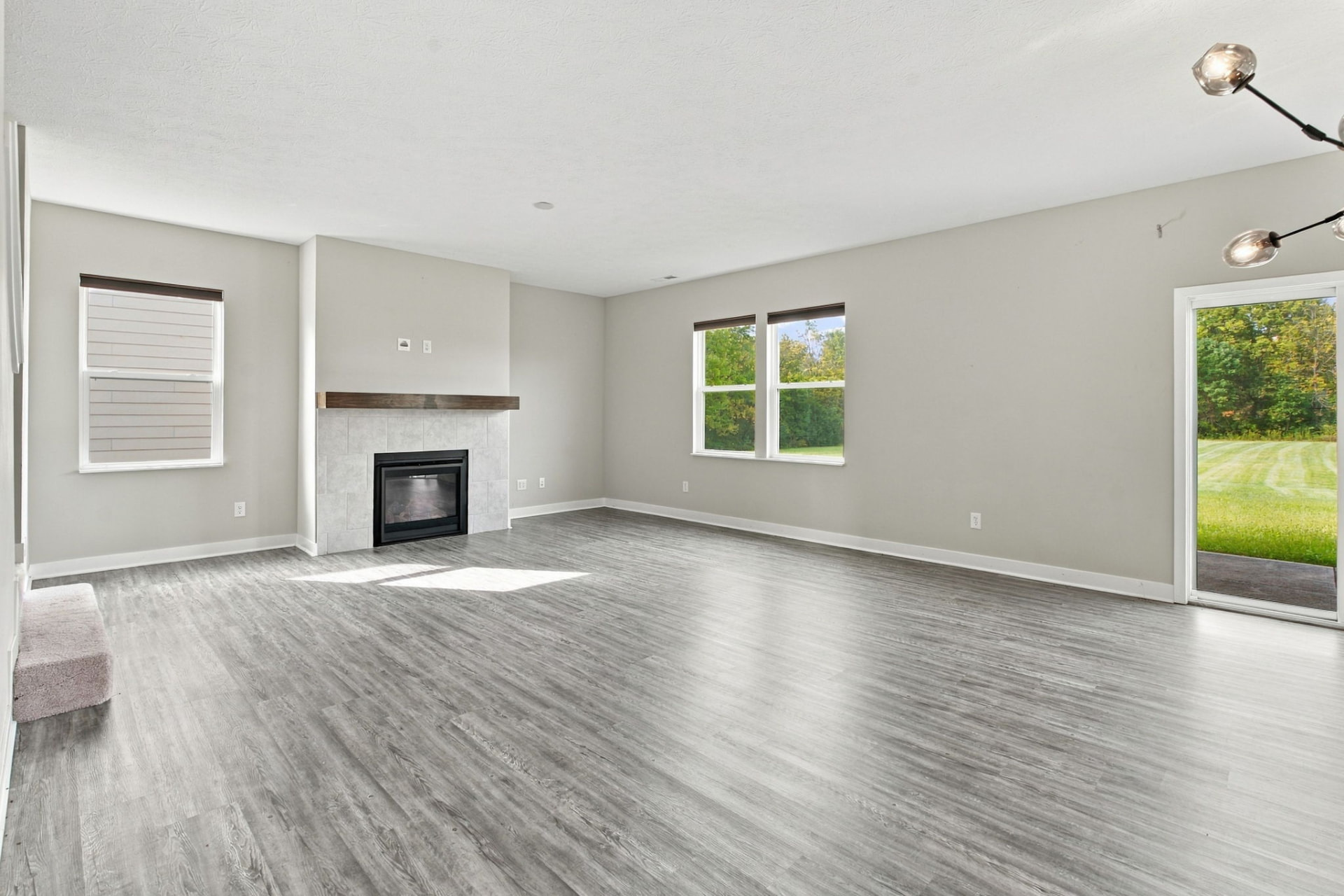 Living room at 16352 Sedalia Drive with gas fireplace, large windows and sliding patio doors